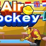 To personer spiller airhockey ved et bord i en farverig hal med forskellige flag i baggrunden