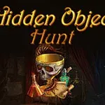 Gyldne bogstaver Hidden Object Hunt over et bord med en kranium dekoreret med bånd, ruller, kolber og et timeglas