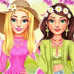 To unge kvinder i farverige, forårsagtige outfits med blomsterpynt i håret, foran en sløret baggrund med lyserøde blomster