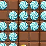 Blå-hvide bolsjer på en bræt baggrund af brune chokoladefirkanter
