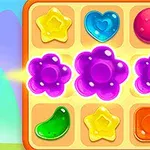 Farverigt brætspil med ni glinsende brikker i form af blomster, stjerner, hjerte, og andre geometriske figurer