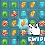 Et spilbræt med farverige slik-ikoner og en pegende hånd, der viser en swipe-bevægelse