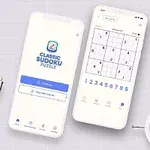 To smartphones vises med en Sudoku-app åben, omgivet af en urteplante, en metalpen og et hvidt vækkeur på en grå baggrund