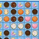 Et gitter med forskellige småkageformer, herunder stjerner, katte, hjerter og chokoladecookies
