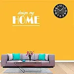 En stue med en grå sofa, et sofabord, en vase med blomster, en gul væg med teksten design my HOME, en vægur, en lampe og en kvinde til venstre