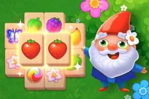 En glad nisse med rødt hat og hvidt skæg står ved siden af træbrikker med farverige frugtmotiver og blomster på en grøn baggrund