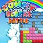 Farverige blokke og en regnbue med ordet GUMMY BLOCKS BATTLE omgivet af skyer på en blå himmelbaggrund