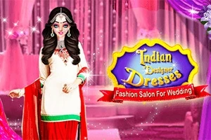 En kvinde i en traditionel indisk kjole står foran en lyserød baggrund med et skilt, der viser teksten Indian Designer Dresses og Fashion Salon For Wedding