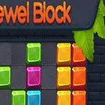 Farverige juvelblokke er arrangeret på en sort murstensbaggrund under en orange Jewel Block overskrift med grønne blade