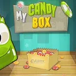 Grønt tegneserieagtigt væsen ved siden af en kasse fyldt med slik, med teksten My Candy Box øverst