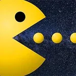 Gul cirkel med en åben mund, der nærmer sig tre mindre gule cirkler på en stjernehimmel baggrund