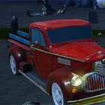 Rød retro lastbil parkeret på en kirkegård om natten med gravsten i baggrunden