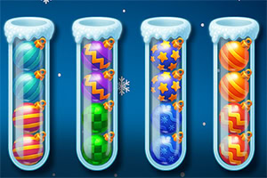 Fire reagensglas med farverige, mønstrede kugler indeni og snefnug i baggrunden