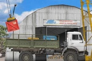 En lastbil parkeret foran et lager med et skilt CARGO DELIVERY, mens en kran løfter en rød container