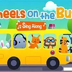 Gul bus med glade dyr ombord og teksten Wheels on the Bus og Sing Along øverst, omgivet af et grønt landskab