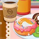 To donuts med farverigt fyld og frugt sammen med en kop kaffe på et bord